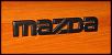 FS: blacked-out MAZDA rear emblem-black-mazda-rear-emblem-off-car-.jpg
